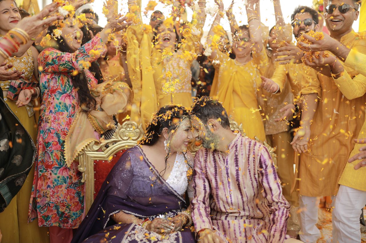 Crafting Captivating Headlines: Your awesome post title goes here Indian couple joyfully participates in a vibrant Haldi ceremony surrounded by friends and family.